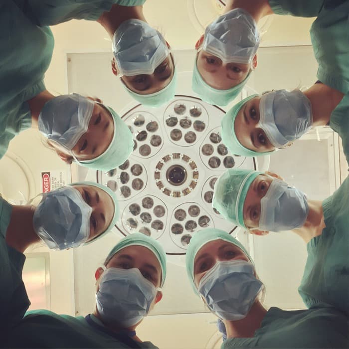 Surgical team gathered around an operating light